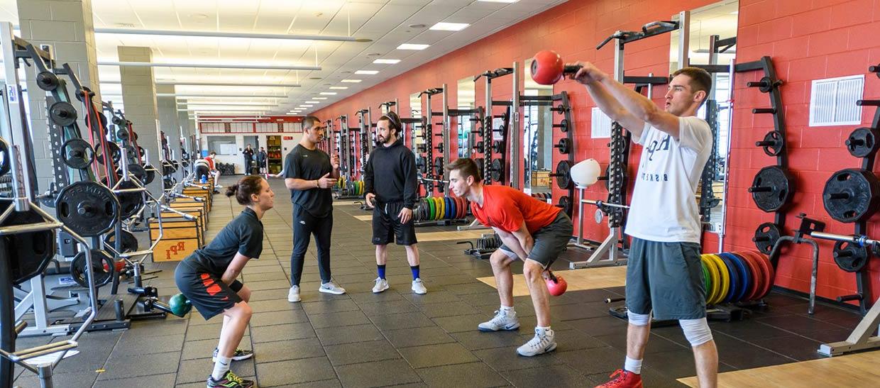 Students training with an instructor in a gym